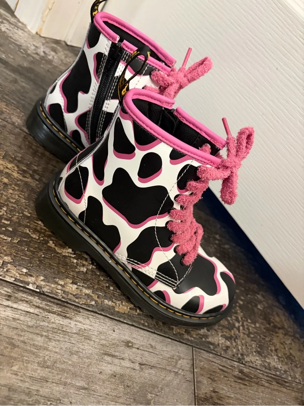 Dr Martin’s Black & White Cow Print Combat Boots with Pink Trim and Laces